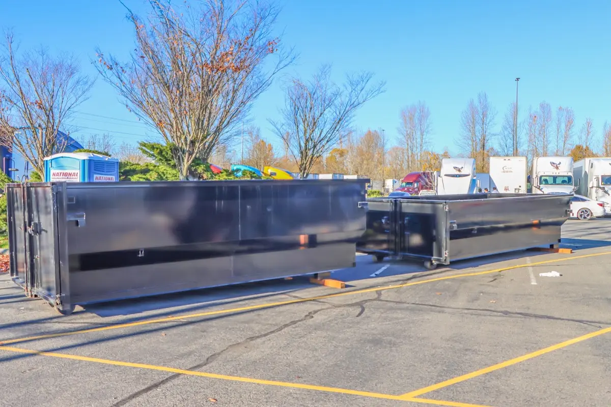 Professional dumpster rental service with roll-off container on residential driveway in Glen Ridge